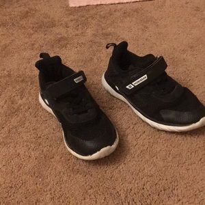 Black tennis shoes. Velcro.